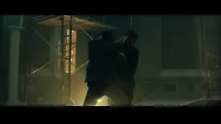two men fighting in dimly lit warehouse — John Wick