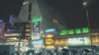 busy street at night with Lumine 2 — Weathering with You
