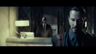 man standing behind hotel lobby desk — John Wick