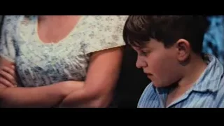 Man in striped shirt looking out window — Harry Potter and the Philosophers Stone