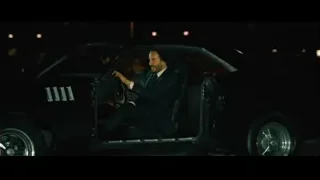 man in suit driving car at night — John Wick: Chapter 4