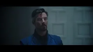 man in blue suit in dimly lit room — Doctor Strange 2
