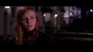 young woman with serious expression in dim room — Spider Man 2