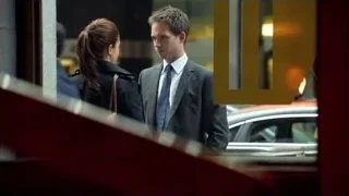 Man and woman conversing by window — Suits