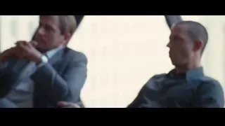 three men in suits in room with windows — The Big Short