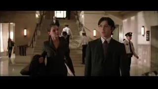 People walking down building hallway — Batman