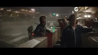 two men on rainy bridge at night — Ford v Ferrari