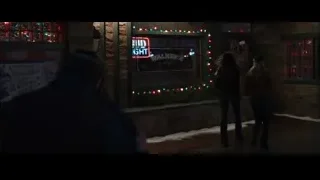 Man in front of building with neon sign — Iron Man 3