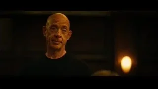 Bald man's face in dimly lit room — Whiplash