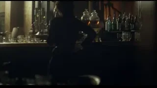 Woman holding whiskey behind bar counter — Peaky Blinders