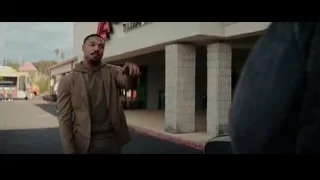 Man standing before Avenue building — Creed 3
