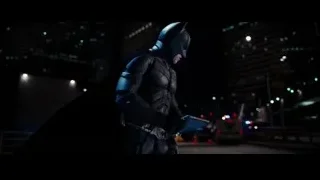 Batman standing with gun on city street — Batman: The Dark Knight Rises
