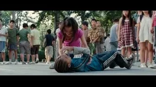 Girl kneeling over unconscious boy in park — The Karate Kid