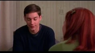 young man and woman talking on couch — Spider Man