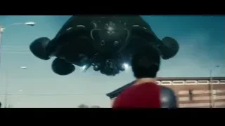 Man in red cape by damaged car — Superman: Man of Steel