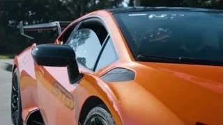 orange sports car on winding road — Sports Cars