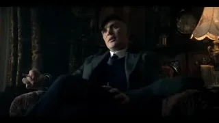man holding cigarette in dimly lit living room — Peaky Blinders