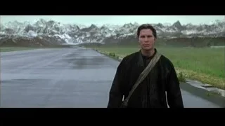 man in black robe by wet road with mountains — Batman