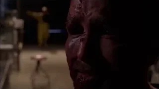 man with bloody face in dimly lit room — Breaking Bad
