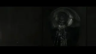 Tall figure in dark room with circular hole — The Amazing Spider Man