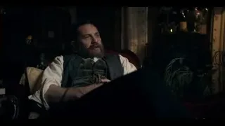 man with beard sitting in dimly lit room — Peaky Blinders