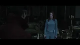 Woman and man in dimly lit room — Doctor Strange 2
