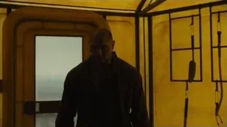 Bald man silhouette in dimly lit room — Blade Runner 2049