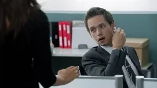 Man in suit sitting at office desk — Suits