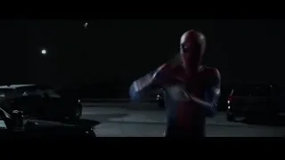 Spiderman standing in parking lot at night — The Amazing Spider Man