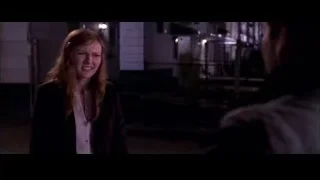 young woman and man conversing in dimly lit room — Spider Man 2