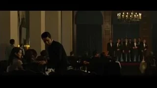 People in formal attire in large room — The Social Network