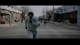 Man in hoodie running on street — Creed