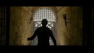 man walking through stone alleyway with sword — Gladiator 2