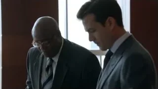Two men in suits standing in a room — Suits
