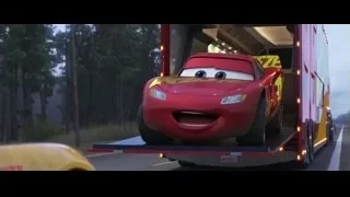 Lightning McQueen loaded onto red trailer on road — Cars 3
