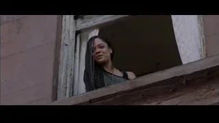 Young woman looking out window in old building — Creed