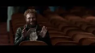 red haired man speaking in empty auditorium — Steve Jobs