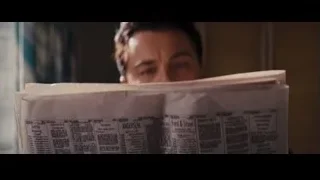 man peeking over newspaper — The Wolf Of Wall Street