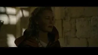 woman in red cloak contemplating in stone room — Gladiator 2