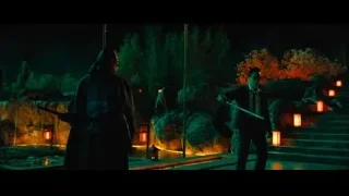 Two men with sword in dim garden — John Wick: Chapter 4