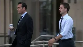 Two men in suits walking with coffee — Suits