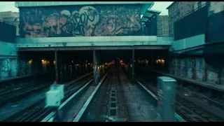 person looking out dimly lit subway train — Joker