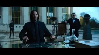 man at desk in grand room — John Wick: Chapter 4