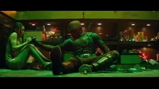 Man with mask and gun in dimly lit room — Deadpool 2
