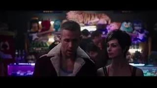 Man in red jacket talking to woman in bar — Deadpool