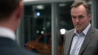 men in suits talking by glass door — Suits