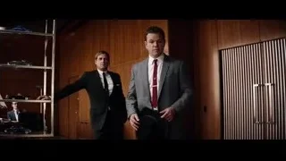 two men in suits in room with wooden walls — Ford v Ferrari