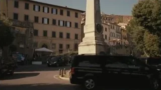 Stone obelisk with clock in town square — Succession