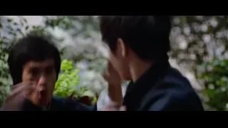Two men conversing in wooded area — Bruce Lee: Enter The Dragon