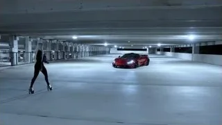 woman walking to red sports car in garage — Sports Cars